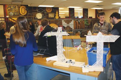 Principles of Engineering
ORRHS teacher Tom Norris’ Principles of Engineering class tested on March 29 to see if the robotic balsa wood cranes students designed could lift at least two pounds. Six groups of 2-3 students designed their own cranes, motors, and pulley systems using only a set limited supply of materials. Pictured left: Davis Mathieu (left) adds more weights while Norris (right) observes. Photos by Jean Perry
