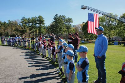 Opening Day
Rick Plunkett throws out the first pitch in memory of his son Ryan Plunkett, for whom the Old Rochester Youth Baseball League has commemorated a new award going to the league’s best pitcher. Rick Plunkett is also pictured with Rochester Police Officer Austin Alves, who was Ryan Plunkett’s catcher when the two played together on the A’s of the ORYB Major League. Alves recalled a home run Ryan Plunkett hit over the left-field wall that got caught up in the top of the batting cage at Gifford Park. 
