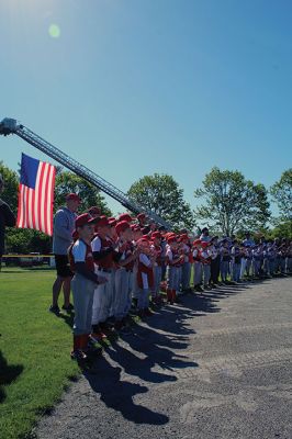 Opening Day
Rick Plunkett throws out the first pitch in memory of his son Ryan Plunkett, for whom the Old Rochester Youth Baseball League has commemorated a new award going to the league’s best pitcher. Rick Plunkett is also pictured with Rochester Police Officer Austin Alves, who was Ryan Plunkett’s catcher when the two played together on the A’s of the ORYB Major League. Alves recalled a home run Ryan Plunkett hit over the left-field wall that got caught up in the top of the batting cage at Gifford Park. 
