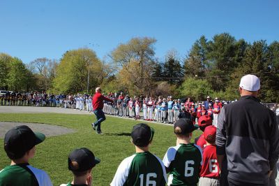 Opening Day
Rick Plunkett throws out the first pitch in memory of his son Ryan Plunkett, for whom the Old Rochester Youth Baseball League has commemorated a new award going to the league’s best pitcher. Rick Plunkett is also pictured with Rochester Police Officer Austin Alves, who was Ryan Plunkett’s catcher when the two played together on the A’s of the ORYB Major League. Alves recalled a home run Ryan Plunkett hit over the left-field wall that got caught up in the top of the batting cage at Gifford Park. 
