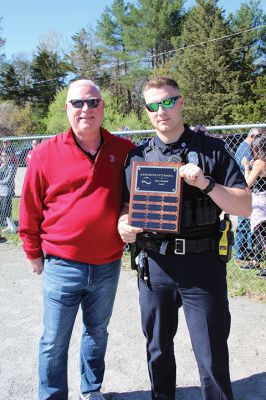 Opening Day
Rick Plunkett throws out the first pitch in memory of his son Ryan Plunkett, for whom the Old Rochester Youth Baseball League has commemorated a new award going to the league’s best pitcher. Rick Plunkett is also pictured with Rochester Police Officer Austin Alves, who was Ryan Plunkett’s catcher when the two played together on the A’s of the ORYB Major League. Alves recalled a home run Ryan Plunkett hit over the left-field wall that got caught up in the top of the batting cage at Gifford Park. 
