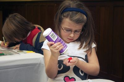 Holiday Ornaments
Elizabeth Pinzino applies glue to a pompom for her Christmas stocking ornament at the Mattapoisett Library on Saturday, December 15.  Photo by Eric Tripoli.
