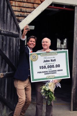 Publishers Clearing House Prize Patrol 
Yes, the Publishers Clearing House Prize Patrol really does exist and, yes, people actually do win – just ask John Hall of Rochester! Wearing only socks on his feet, Hall exited his Snipatuit Road home on April 15 and was greeted by PCH Prize Patroller Howie Guja who was holding a giant check for $50,000 with Hall’s name on it, roses, and a bottle of bubbly. Photos by Jean Perry
