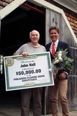 Publishers Clearing House Prize Patrol 
Yes, the Publishers Clearing House Prize Patrol really does exist and, yes, people actually do win – just ask John Hall of Rochester! Wearing only socks on his feet, Hall exited his Snipatuit Road home on April 15 and was greeted by PCH Prize Patroller Howie Guja who was holding a giant check for $50,000 with Hall’s name on it, roses, and a bottle of bubbly. Photos by Jean Perry
