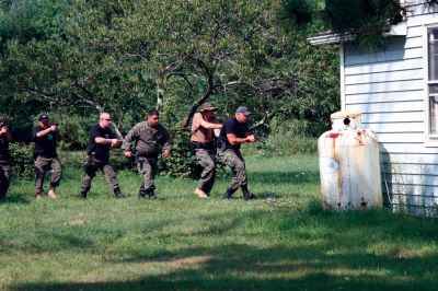 PD Training
On August 20, 2009, police officers from the Southeastern Massachusetts Law Enforcement Council Rapid Response team conducted training exercises at 73 County Road in Rochester from 8:00 am to 3:00 pm. 25 officers from various local police departments, including Mattapoisett, Rochester and Marion, gathered to practice flash bangs and simunitions. Photo by Paul Lopes

