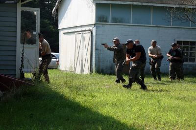 PD Training
On August 20, 2009, police officers from the Southeastern Massachusetts Law Enforcement Council Rapid Response team conducted training exercises at 73 County Road in Rochester from 8:00 am to 3:00 pm. 25 officers from various local police departments, including Mattapoisett, Rochester and Marion, gathered to practice flash bangs and simunitions. Photo by Paul Lopes
