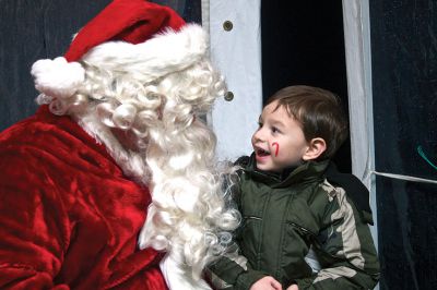 Holiday In The Park
Santa Claus made an appearance in Mattapoisett at the Holiday In The Park celebration on Saturday, December 5. Zachary Medeiros of Mattapoisett tells Santa what he wants for Christmas this year.  Photo by Eric Tripoli.
