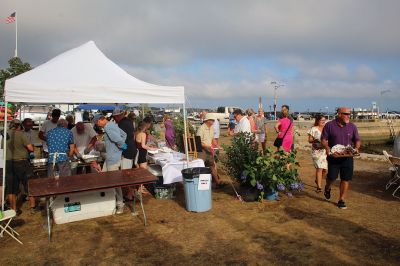 Great Picnic
Attendees at Friday night’s “Great Picnic” on the one-acre Munro preserve overlooking Mattapoisett Harbor enjoyed live music and adorned their tables with creatively competitive centerpieces featuring everything from a palm tree to pickleballs. Mattapoisett Land Trust Vice President Peter Davies told the Wanderer that the Mattapoisett Museum and the MLT have jointly organized the event for five nonconsecutive years. Proceeds from the annual event support their programs. Photos by Mick Colageo
