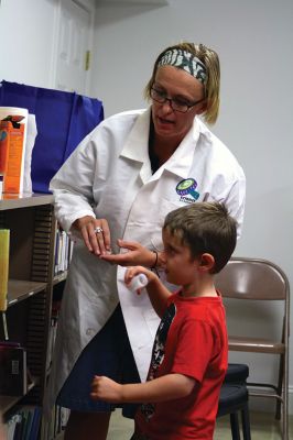 Science Roadshow
The Children’s Museum in Easton brought its Science Roadshow to the Plumb Library on August 6, and showed kids how to make a rocket out of a film canister (remember those?) and an Alka-Seltzer, and create sizzling artwork with vinegar, food coloring, and baking soda. Photos by Jean Perry
