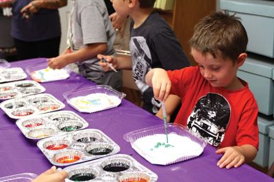 Science Roadshow
The Children’s Museum in Easton brought its Science Roadshow to the Plumb Library on August 6, and showed kids how to make a rocket out of a film canister (remember those?) and an Alka-Seltzer, and create sizzling artwork with vinegar, food coloring, and baking soda. Photos by Jean Perry
