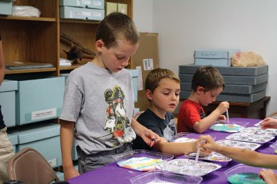 Science Roadshow
The Children’s Museum in Easton brought its Science Roadshow to the Plumb Library on August 6, and showed kids how to make a rocket out of a film canister (remember those?) and an Alka-Seltzer, and create sizzling artwork with vinegar, food coloring, and baking soda. Photos by Jean Perry
