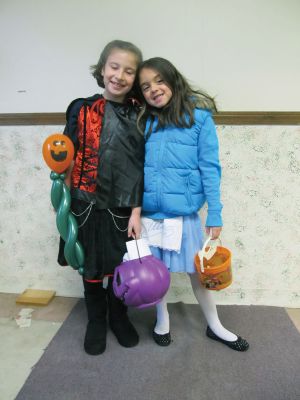 Rochester Halloween
Vampiress Audrey Blanchard and Taylor Amaral (as Alice from Alice in Wonderland) got treats and balloons at the October 29, 2011 Plumb Corner Halloween party. Photo by Shawn Sweet.
