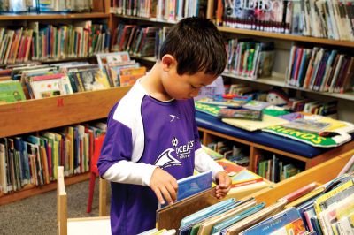 Summer Reading Program
Grady Daniels looks over his options at Plumb Library on September 15, 2012.  Photo by Eric Tripoli. 
