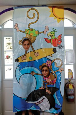 Summer Reading Program
Ava DeMaggio (the monkey who is using a shark as a surf board) and Sarah Sollauer (the hand-standing-surfing monkey) pose for a photo at Plumb Library during the party to celebrate the success of "Dream Big: Read," a new summer reading program designed to encourage students and their families to read all summer long.  Photo by Eric Tripoli.
