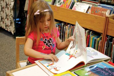 Summer Reading Program
Madelyn McCarthy, who is not yet old enough to read, thumbs through a picture book in the kids' section of Plumb Library during the party celebrating the success of the "Dream Big: Read" summer reading program on Saturday, September 15, 2012.  Photo by Eric Tripoli.
