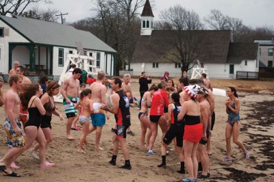 Christmas Day Swim
On Christmas Day 2014, about 50 hardy souls, young and old alike, ran with yelps of joy into 42-degree winter waters at Mattapoisett’s Town Beach. This annual event raises funds for Helping Hands and Hooves, a nonprofit organization in Mattapoisett that provides horseback riding lessons and therapeutic sessions for people with special needs. Photos by Marilou Newell
