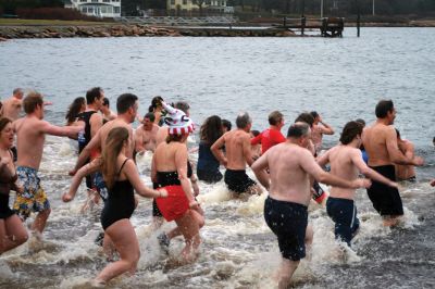 Christmas Day Swim
On Christmas Day 2014, about 50 hardy souls, young and old alike, ran with yelps of joy into 42-degree winter waters at Mattapoisett’s Town Beach. This annual event raises funds for Helping Hands and Hooves, a nonprofit organization in Mattapoisett that provides horseback riding lessons and therapeutic sessions for people with special needs. Photos by Marilou Newell
