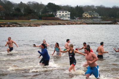 Christmas Day Swim
On Christmas Day 2014, about 50 hardy souls, young and old alike, ran with yelps of joy into 42-degree winter waters at Mattapoisett’s Town Beach. This annual event raises funds for Helping Hands and Hooves, a nonprofit organization in Mattapoisett that provides horseback riding lessons and therapeutic sessions for people with special needs. Photos by Marilou Newell
