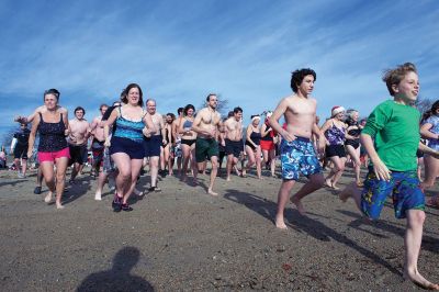 14th Annual Christmas Day Swim
The Helping Hands and Hooves 14th Annual Christmas Day Swim got a helping hand from the unseasonably warm weather, drawing in roughly 80 participants who took the polar plunge to support the organization’s therapeutic horseback riding program for adults with special needs. Photos by Colin Veitch
