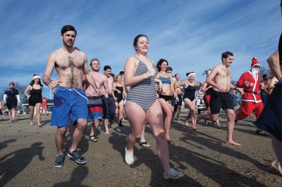 14th Annual Christmas Day Swim
The Helping Hands and Hooves 14th Annual Christmas Day Swim got a helping hand from the unseasonably warm weather, drawing in roughly 80 participants who took the polar plunge to support the organization’s therapeutic horseback riding program for adults with special needs. Photos by Colin Veitch
