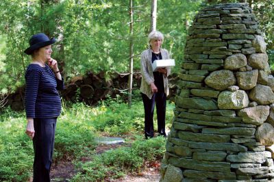 Point Road Memorial Forest
Point Road Memorial Forest Advisory Committee members Tess Cederholme (left) and Chrissie Bascomb (right) led a tour and information session on the cremation cemetery located on the land, donated by the Stone family, and maintained by the town of Marion and the Marion Land Trust on Sunday, June 3, 2012.  The stone structure to the right is called a cairn; historically, they have been used as trail markers and grave stones. Photo by Eric Tripoli.
