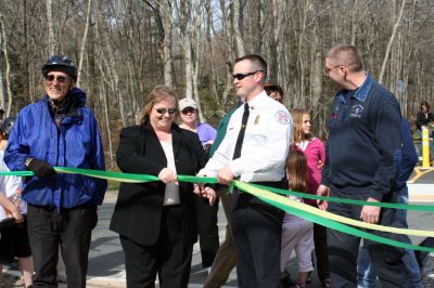 Rail Trail
Bill Straus, State Representative, Steve Kelleher, Chairman of Mattapoisett Rail Trail, and Jordan Collyer, Vice-Chairman of the Mattapoisett Board of Selectman (left to right) cut the ribbon to open the Inauguration of the Mattapoisett Rail Trails Old Colony Mile. Photo by Sarah K. Taylor. 
