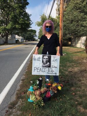 RBG
Regina McIntyre of Angelica Avenue in Mattapoisett erected a small but poignant memorial outside her home to honor Ruth Bader Ginsburg following the Supreme Court Justice’s passing. “I couldn’t travel to Washington, so I decided to place this memorial here to remember her work on behalf of both women and men,” adding: “She was such an example, (a) role model.” It was a family affair as McIntyre’s sister dressed the Ginsburg doll in a hand-sewn robe complete with seed pearl collar and red shoes. 
