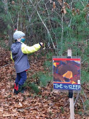 Rochester Land Trust
Wyatt Smith, age 5, places a sunflower seed apple on a branch along the Trail Tale at Church Preserve on Marion Road. The December 18 event was a collaboration of the Rochester Land Trust and Plumb Corner Library. The storyboards along the trail tell the story of animals preparing for winter hibernation.
