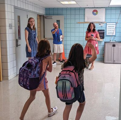 Rochester Memorial School
Principal Derek Medeiros, Grade 3 teacher Nikita Higgins and School Adjustment Counselor Sharon Cruz welcome students on the opening day Tuesday morning at Rochester Memorial School. Inside, students are greeted by, from left, new Instrumental Music Teacher Kaitlyn Laprise, Physical Education teacher Kevin Woodward and Choral Music teacher Sue Audette. RMS Parent Teacher Organization president Kirsten Jimenez with her daughter Ana Grace. Photos courtesy of Erin Bednarczyk
