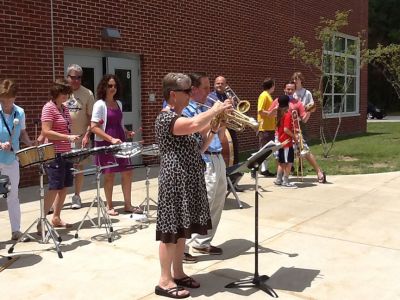 RMS Send Off
Every year on the last day of school, Rochester Memorial School staff and faculty members give their students a VIP send-off to bid them farewell for the summer. Buses circle the parking lot and staff play music while students frantically wave goodbye from the passing buses. By Jean Perry
