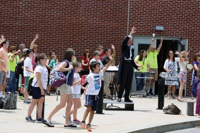 Last Day of School
June 19 was the last day of school at RMS, and the teachers and staff celebrated with their traditional student sendoff. Conductor Danni Kleiman led the teachers in song as the busses full of waving students looped around the parking lot before heading off toward summer break. Photos by Jean Perry
