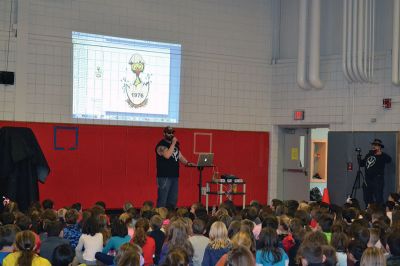 “The Machine” Jesse Green
Famous chainsaw artist and star of the National Geographic Channel TV show American Chainsaw, “The Machine” Jesse Green presented the RMS students with a one-of-a-kind chainsaw sculpture of Bandit, the RMS mascot, on December 15. Bandit will stand firm and tall (much taller than most of the students) at the school from now on, thanks to the coordination of the RMS PTO. Photos by Jean Perry
