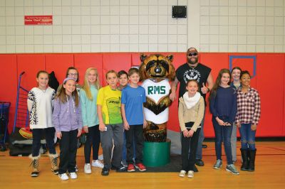 “The Machine” Jesse Green
Famous chainsaw artist and star of the National Geographic Channel TV show American Chainsaw, “The Machine” Jesse Green presented the RMS students with a one-of-a-kind chainsaw sculpture of Bandit, the RMS mascot, on December 15. Bandit will stand firm and tall (much taller than most of the students) at the school from now on, thanks to the coordination of the RMS PTO. Photos by Jean Perry
