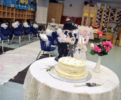  “Q” and “U” 
Deborah Bacciocchi’s kindergarten class at RMS celebrated a wedding of “Q” and “U” on May 16. The bride (a wooden letter "Q") wore a gown sewn with pieces from Bacchiocchi’s wedding gown and the groom wore mixed media/Sharpie formalwear. The gift registry yielded essentials like quarters, quilts, queens, and quartz, all elaborately wrapped by the kids. The reception followed with music, dancing, and cake. Photos by Erin Bednarczyk
