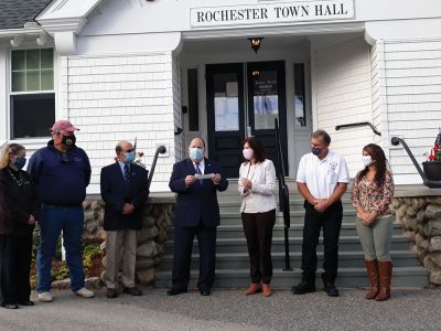 Rochester Cares
Plymouth County Treasurer Thomas O’Brien presents the first CARES Act reimbursement check to Rochester Town Administrator Suzanne Szyndlar on Friday outside Town Hall. Pictured from left: COA Director Cheryl Randall, Selectman Brad Morse, Selectman Paul Ciaburri, Thomas O’Brien, Suzanne Szyndlar, Fire Chief Scott Weigel, and Administrative Assistant Amanda Baptiste. Photo by Mick Colageo
