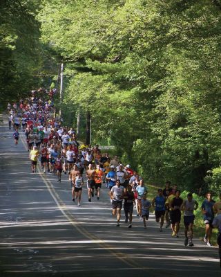 Racing for Rations
The Rochester Road Race saw 348 runners finish on August 13, 2011. Although there were 20 fewer runners from last year, the event still managed to raise 453 pounds of food for Damien's Pantry in Wareham. The men's winner was Julien De Marian of Paris, France, with a time of 15:57, and the women's winner was Jennifer Almeida of Acushnet with a time of 20:19. Photo by Jim Fox. August 18, 2011 edition
