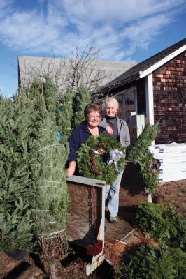 Rochester Green
'Tis the season, once more! On the Saturday after Thanksgiving, November 26, 2011, locals stopped by the Rochester Women's Clubhouse to pick up their fresh wreaths and trees. The proceeds from the sale helped the Rochester Women's Club purchase a new roof for their Clubhouse. The tree and wreath sale will continue on the weekends of December 3 and 4 and December 10 and 11 from noon to 2:00 pm. Left to right, Club members Nancy Boutin and Marsha Hartley helped sell wreaths and trees. Photo by Robert Chiarito
