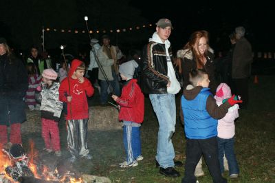 Moonlit Salty
Everyone had a blast at Saltys Moonlight Soiree at Dunseith Gardens on November 7, 2009. The Mattapoisett Land Trust provided sticks, marshmallows, chocolate, graham crackers, and entertainment. Children roasted their marshmallows while they enjoyed Big Ryan from Big Ryans Tall Tales. Photo by Anne OBrien-Kakley.
