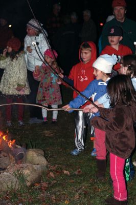 Moonlit Salty
Everyone had a blast at Saltys Moonlight Soiree at Dunseith Gardens on November 7, 2009. The Mattapoisett Land Trust provided sticks, marshmallows, chocolate, graham crackers, and entertainment. Children roasted their marshmallows while they enjoyed Big Ryan from Big Ryans Tall Tales. Photo by Anne OBrien-Kakley.
