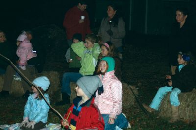 Moonlit Salty
Everyone had a blast at Saltys Moonlight Soiree at Dunseith Gardens on November 7, 2009. The Mattapoisett Land Trust provided sticks, marshmallows, chocolate, graham crackers, and entertainment. Children roasted their marshmallows while they enjoyed Big Ryan from Big Ryans Tall Tales. Photo by Anne OBrien-Kakley.
