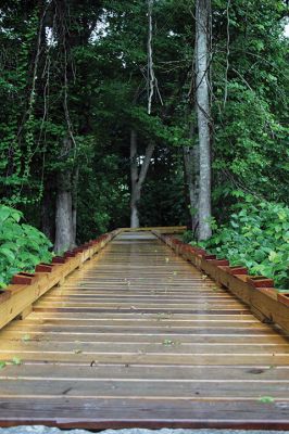 Osprey Marsh Accessible Boardwalk
Despite a downpour perfectly timed for its planned gathering on Friday off Point Road in Marion, the Sippican Lands Trust celebrated the completion of the new Osprey Marsh Accessible Boardwalk. Executive Director Jim Bride and president Alan Harris held a live Zoom meeting for those who could not attend, and some of the donors for the project assisted in the ribbon-cutting. The boardwalk is open by appointment. See story by Marilou Newell. Photo by Mick Colageo
