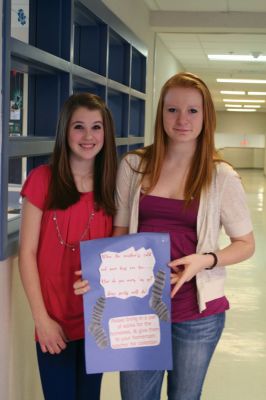 Socks for the Needy
Carly Pellissier, left, and Katie Zartman, right, pose with a poster that they made to promote the Socks for the Needy program at Old Rochester Regional Junior High School. The school collected new socks to send to Turning Point, a non-profit agency that helps area residents in need. Photo by Anne OBrien-Kakley.
