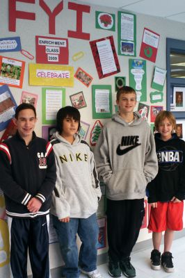 Wall of Celebration
Left to right: Nick Bergstein, Casey MacKenzie, Andrew Dessert, and Seth Richard proudly display their Wall of Celebration at the Old Rochester Regional Junior High School. The wall shows all the different December holiday celebrations from around the world. Photo by Anne OBrien-Kakley.
