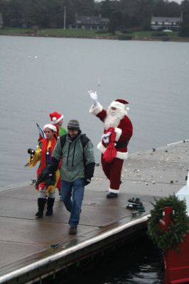 Santa's Arrival
Marion children gave a rock stars welcome to Santa Claus, who arrived at Marions Annual Holiday Stroll by boat on December 13. The pouring rain didnt stop Santa from spreading candy and holiday cheer to the crowd of exciting children. Clydesdale horses waited patiently to take visitors on a stroll through the village, and the town Christmas tree was lit at Bicentennial Park. Photo by Anne OBrien-Kakley.
