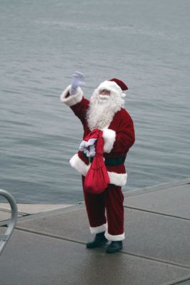 Santa's Arrival
Marion children gave a rock stars welcome to Santa Claus, who arrived at Marions Annual Holiday Stroll by boat on December 13. The pouring rain didnt stop Santa from spreading candy and holiday cheer to the crowd of exciting children. Clydesdale horses waited patiently to take visitors on a stroll through the village, and the town Christmas tree was lit at Bicentennial Park. Photo by Anne OBrien-Kakley.
