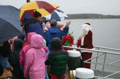 Santa's Arrival
Marion children gave a rock stars welcome to Santa Claus, who arrived at Marions Annual Holiday Stroll by boat on December 13. The pouring rain didnt stop Santa from spreading candy and holiday cheer to the crowd of exciting children. Clydesdale horses waited patiently to take visitors on a stroll through the village, and the town Christmas tree was lit at Bicentennial Park. Photo by Anne OBrien-Kakley.
