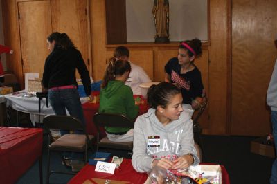 Christmas Holiday Shop
St. Anthonys and St. Ritas parishioners combined efforts to give the community a Christmas Holiday Shop and Celebration on Saturday, December 5, 2009. The basement of St. Anthonys church was decked out in snowflakes, wreaths, bells, bows, and a Santa sleigh. Santa listened patiently as children told him what they wanted for Christmas. A beautiful bake table tempted visitors with gooey confections and warm malasadas were enjoyed by all. Photo by Anne OBrien-Kakley.
