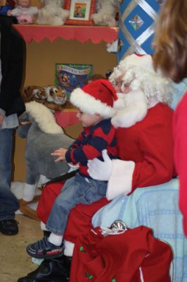 Christmas Holiday Shop
St. Anthonys and St. Ritas parishioners combined efforts to give the community a Christmas Holiday Shop and Celebration on Saturday, December 5, 2009. The basement of St. Anthonys church was decked out in snowflakes, wreaths, bells, bows, and a Santa sleigh. Santa listened patiently as children told him what they wanted for Christmas. A beautiful bake table tempted visitors with gooey confections and warm malasadas were enjoyed by all. Photo by Anne OBrien-Kakley.
