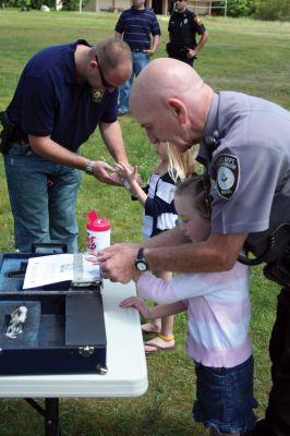 Safety Days
The Marion Police Brotherhood hosted their first annual Public Safety Day at Marion's Silvershell Beach on Saturday, June 13. The event included the installation of child safety seats in residents' vehicles, fingerprint and photo id cards for children along with displays from a variety of local, state and federal government public safety agencies. Photo by Robert Chiarito.
