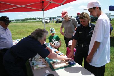 Safety Days
The Marion Police Brotherhood hosted their first annual Public Safety Day at Marion's Silvershell Beach on Saturday, June 13. The event included the installation of child safety seats in residents' vehicles, fingerprint and photo id cards for children along with displays from a variety of local, state and federal government public safety agencies. Photo by Robert Chiarito.
